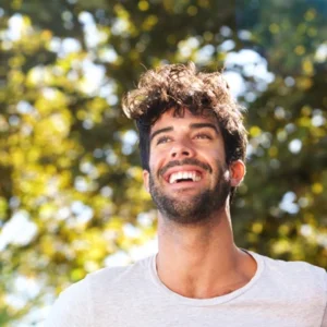 close up laughing man with beard outside