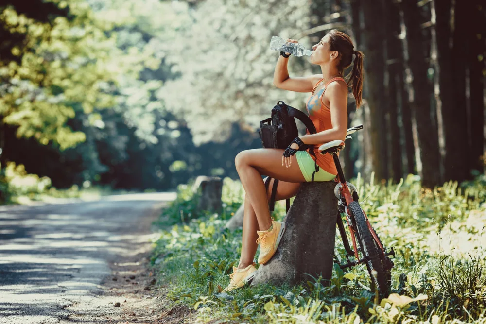 women riding a bike in nature