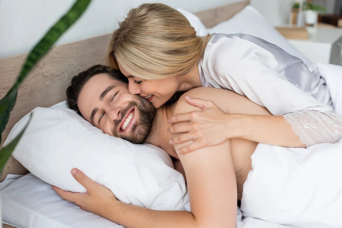 blonde woman smiling next to man