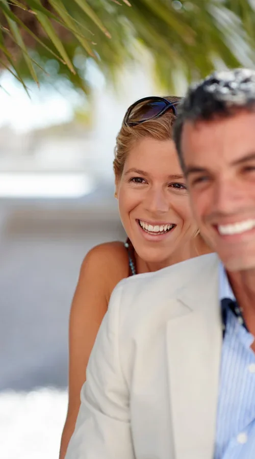 women and man smiling on vacation